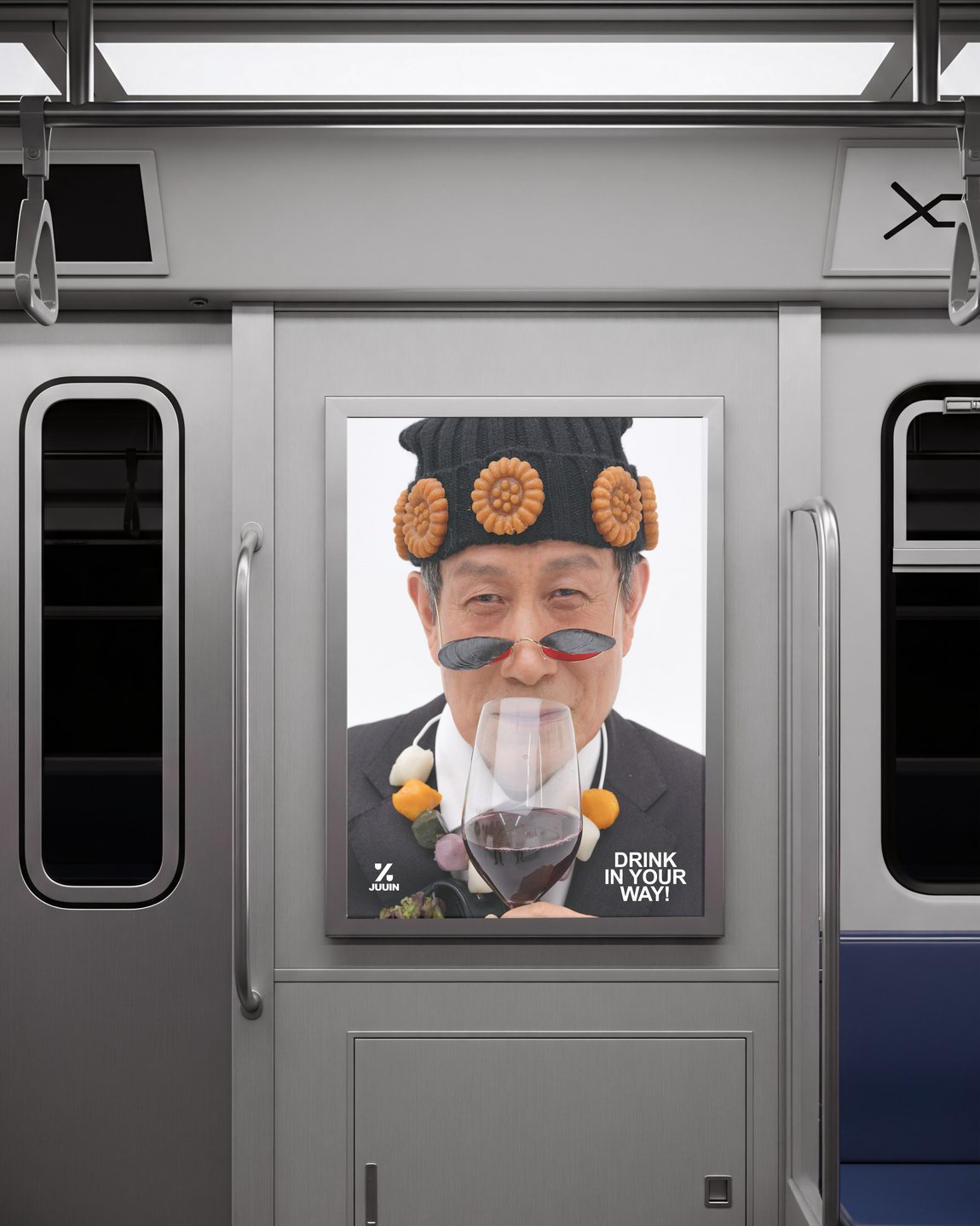 A Juuin subway poster showing a man in a food-covered hat and sunglasses raising a glass of wine
